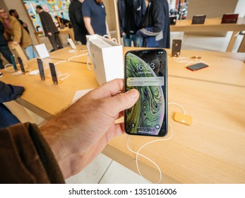 Paris, France - Mar 19 2019: Man POV Personal Perspective Holding IPhone XS Inside The New Apple Store Champs-Elysees Looking At The Gold Iphone With Prix Price App Running