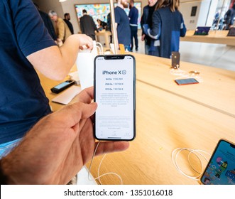 Paris, France - Mar 19 2019: Man POV Personal Perspective Holding IPhone XS Inside The New Apple Store Champs-Elysees - Showing Prices In Euros - French Flagship Store 