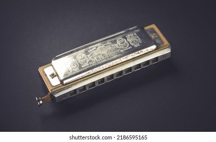 Paris - France - March 1, 2022 : Vintage M. Hohner harmonica isolated on a black background