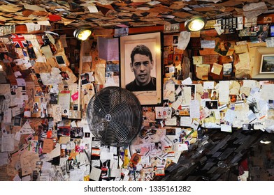 PARIS, FRANCE, MARCH, 2013: Thousands of photographs and a portrait of singer-songwriter Jacques Brel in a bar in Montmartre. 
