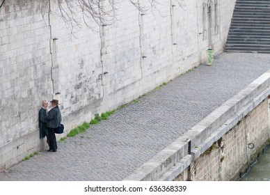 PARIS, FRANCE - MARCH 28, 2010 : A Sweet Middle Age Couple Fondling Each Other By The Seine River