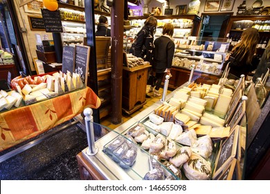 PARIS, FRANCE - MARCH 29 : French Cheese Shop With Dozens Of Kinds Of Chees And Customers Choosing Among Them On March 29th 2013 In Paris, France 