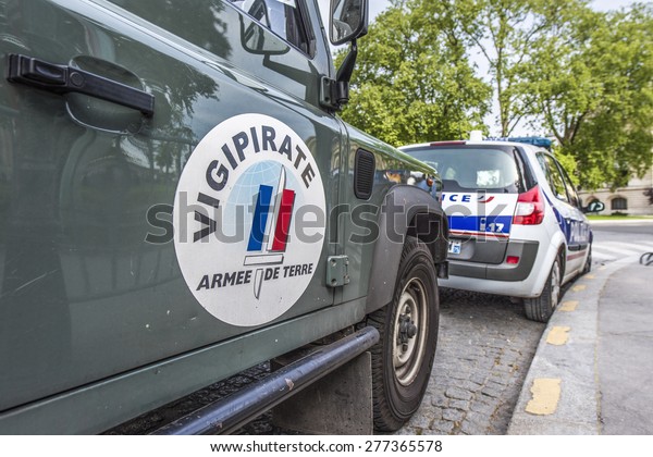 PARIS, FRANCE - MAY 12, 2015 : French army car\
and Police car parked in the street to patrol for Plan Vigipirate\
(France\'s national security alert system) against possible\
terrorist attacks.