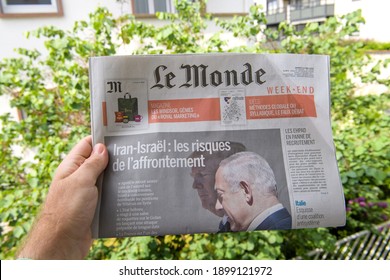 Paris, France - May 12, 2018: POV Male Hand Holding Le Monde French Newspaper With Donald Trump US President And Benjamin Netanyahu Israeli Prime Minister