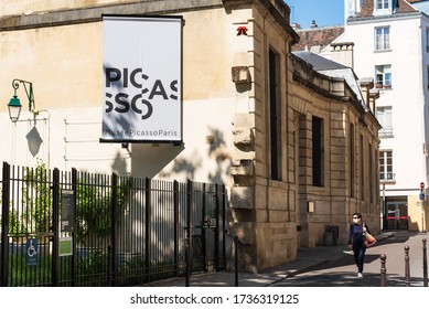 PARIS, FRANCE - MAY 15, 2020: Woman In Protective Mask Walking Near Closed Picasso Museum In Marais Quarter At Empty Street. Covid-19 Lockdown Lifestyle.