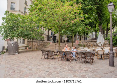 Paris / France - May 16, 2018: A Beautiful Middle Aged Couple Enjoys A Romantic Lunch On The Terrace Of A Cafe In The Historic Neighborhood Of Montmartre.