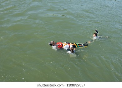 Paris / France - May 19, 2018: Security rescue workers practice a water rescue in the Seine River.