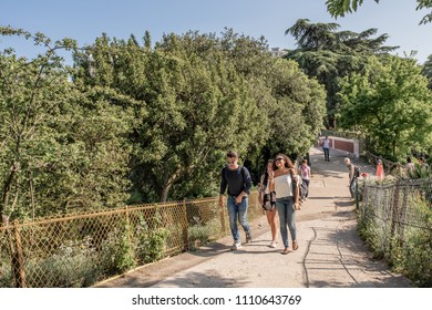 Paris / France - May 19, 2018: Friends Talk And Laugh, Enjoying The Afternoon, In Parc Des Buttes Chaumont, In The Belleville Neighborhood.