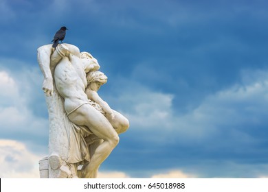 Paris, France - May 2, 2017: Crow on statue The Spartacus Oath in the Tuileries Gardens on May 02, 2017, in Paris, France.