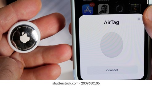 Paris, France - May 2, 2021: Connect Pair Setup AirTag After Unboxing In IPhone Find My App For Keys Headphones Handbag Jacket Luggage Umbrella Wallet Small Device Helps People Keep Track Of