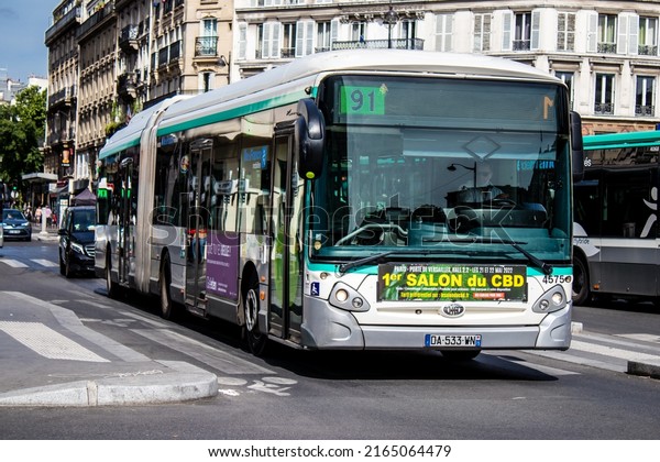 Paris, France - May 21, 2022 Bus driving\
through the streets of Paris during the coronavirus outbreak\
hitting France, wearing a mask is\
mandatory