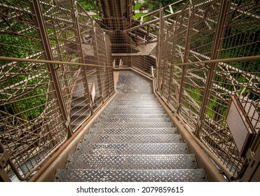 PARIS, FRANCE - MAY 30, 2016: Metal lattice stairs, stairway of the Eiffel Tower, famous wrought-iron tower on the Champ de Mars in Paris, France. Steps for visitors to climb up from the esplanade.
