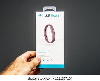 Paris, France - May 30, 2018: Male hand holding Fitbit wristband female sports tracker personal wearable device