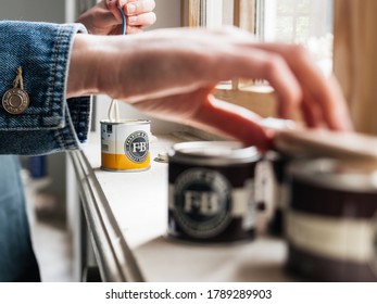 Paris, France - May 30, 2020: Close-up Side View Of Woman Testing Paint Sample Pot Of Farrow And Ball Luxury British Paint Preparing To Paint The Wall And Window Frame