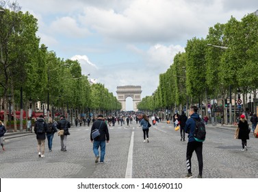 Paris, France - May 5, 2019: People Wandering On Champs Elysees Avenue With Arc De Triomphe In Background. The Avenue Is Closed To Car Traffic On First Sunday Of The Month.
