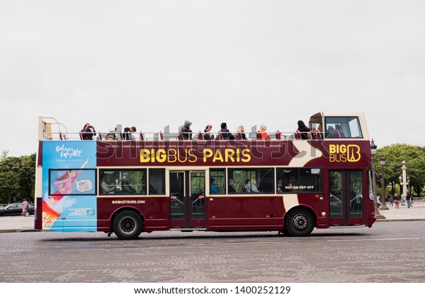 Paris, France - May 5, 2019: Big Bus Tours Paris\
(Les Cars Rouges and The Big Bus Company) open top bus with\
tourists on the Place de la\
Concorde
