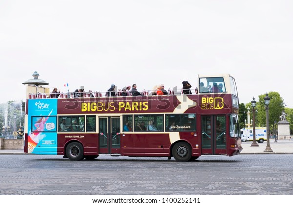 Paris, France - May 5, 2019: Big Bus Tours Paris\
(Les Cars Rouges and The Big Bus Company) open top bus with\
tourists on the Place de la\
Concorde