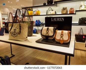 PARIS, FRANCE - MAY 9, 2018: Wide Close-up Of Multiple Ralph Lauren Luxury Leather Handbags On Display Shelves At The Printemps Department Store. Luxury Fashion Industry.