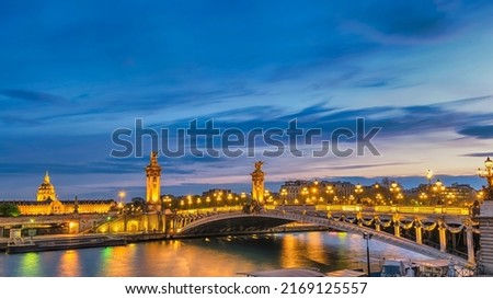 Paris France night city skyline at Seine River with Pont Alexandre III bridge
