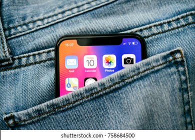 PARIS, FRANCE - NOV 10, 2017: New Apple IPhone X Smartphone Telephone Mobile In Pocket Of Fashion Denim Jeans Pants Trousers With Home Screen Apps