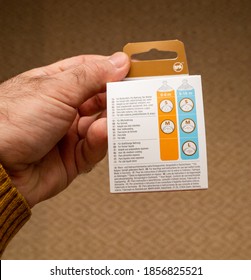 Paris, France - Nov 11, 2020: POV Male Hand Holding Against White Background New Anti-colic Baby Bottle Package For Newborn