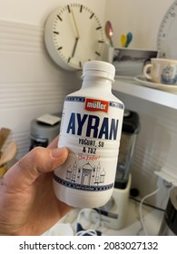 Paris, France - Nov 13, 2021: POV Male Hand Holding In Kitchen Plastic Bottle With Ayran Made With Yogurt, Water And Salt