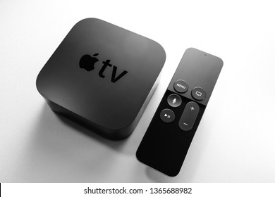Paris, France - Nov 16, 2018: View from above at new black Apple TV 4K media streaming by Apple Computers  against white background - tilt-shift lens used