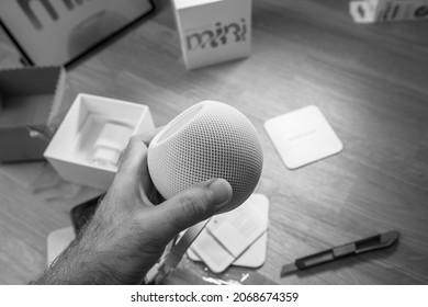 Paris, France - Nov 17, 2020: Black And White Image Man Unboxing The Latest Apple Computers HomePod Mini Smart Speaker Developed By The Computer Firm With Siri The Virtual Assistant That Is Part Of