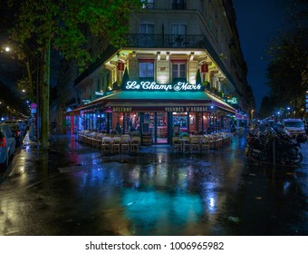 PARIS, FRANCE - NOV 24, 2015: Le Champ De Mars Cafe In Paris, France. Le Champ De Mars Cafe Is A Typical Establishment For Paris. Night Cityscape After Rain.