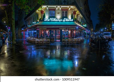 PARIS, FRANCE - NOV 24, 2015: Le Champ De Mars Cafe In Paris, France. Le Champ De Mars Cafe Is A Typical Establishment For Paris. Night Cityscape After Rain.