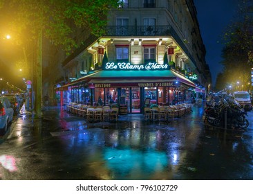 PARIS, FRANCE - NOV 24, 2015: Le Champ De Mars Cafe In Paris, France. Le Champ De Mars Cafe Is A Typical Establishment For Paris. Night Cityscape After Rain.