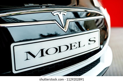 PARIS, FRANCE - NOV 29, 2014: New white Tesla Model S electric car detail of the logotype and inscription on the registration plates