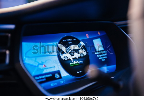 PARIS, FRANCE - NOV 29, 2014:\
POV New Tesla Model S dashboard computer display dashboard screen\
with information and available mileage of the current battery\
status