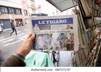 Paris, France - Nov 3, 2020: POV Male Hand At The Newspaper Le Figaro With Cover Featuring Final Day Of Election For U.S. President Race Between Donald Trump And Joe Biden, Democratic Nominee