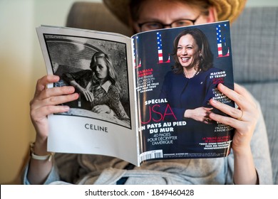 Paris, France - Nov 5, 2020: Woman reading in living room the latest Elle Magazine featuring on cover Kamala Harris Democratic vice presidential nominee for the 2020 election