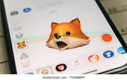 PARIS, FRANCE - NOV 9 2017: Fox animal 3d animoji emoji generated by Face ID facial recognition system with singing face emotion close-up of the new iphone X 10 Display - tilt-shift lens used 