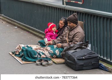 Paris, France, November 2017 - Homeless Family Sitting On The Street