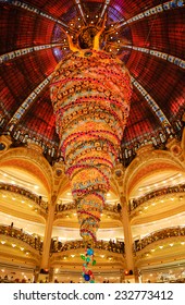 PARIS, FRANCE - NOVEMBER 22, 2014: Christmas tree turned upside down  at Galeries Lafayette and cupola. Galeries Lafayette is well-known Parisian department store located on Boulevard Haussmann.