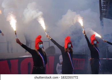Paris, France - Oct. 10, 2020 - The "Mariannes", young female supporters of La Manif pour Tous, wave smoke bombs at a manifestation against the bioethics bill in front of the Ministry of Justice