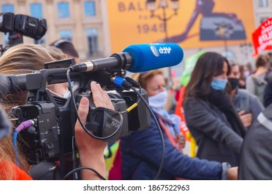 Paris, France - Oct. 10, 2020 - Gathering of journalists and reporters in live television, equipped with cameras, recorders and microphones, performing an interview at Marchons Enfants' demonstration