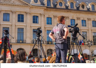 Paris, France - Oct. 10, 2020 - A technician with three tripids and two TV cameras films a demonstration led by Marchons Enfants against the Government's gestational surrogacy and bioethics bill