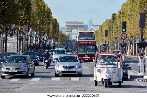 PARIS,\
FRANCE OCT 14, 2014: The Champs-Elysees and the Triumphal Arch de l\
Etoile the most famous avenue of Paris has 1910m and is full of\
stores, cafes and restaurants. In Paris France\
