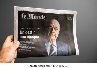 Paris, France - Oct 2, 2019: Male Hand POV Personal Perspective Holding Against Gray Background Le Monde Newspaper With Special Edition Related To The Death Of Former French President Jacques Chirac