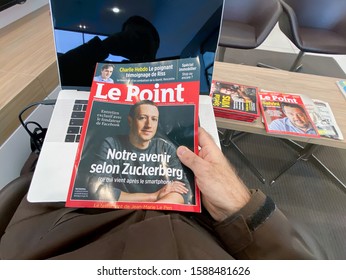 Paris, France - Oct 25, 2019: Man Hand POV Holding Latest Le Point Magazine Newspaper With CEO Of Social Network Mark Zuckerberg On The Cover