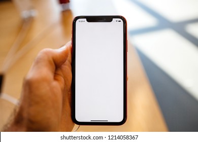 PARIS, FRANCE - OCT 26, 2018: Man Hand Holding Latest IPhone XR Smartphone In Apple Store Computers During The Launch Day Pov At The New Smartphone With Liquid Retina With Black Screen