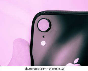 Paris France - Oct 26 2018: Man Hand Holding Latest IPhone XR Featuring An AR Camera And Led Flash Rear View With Single Lens Monochrome Pink Image