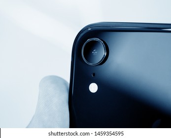 Paris France - Oct 26 2018: Man Hand Holding Latest IPhone XR Featuring An AR Camera Rear View With Single Lens Black And White Image