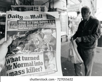 PARIS, FRANCE - OCT 3, 2017: Man buying Daily Mail newspaper with socking title photo at press kiosk about the 2017 Las Vegas Strip shooting in United States with about 60 fatalities and 527 injuries