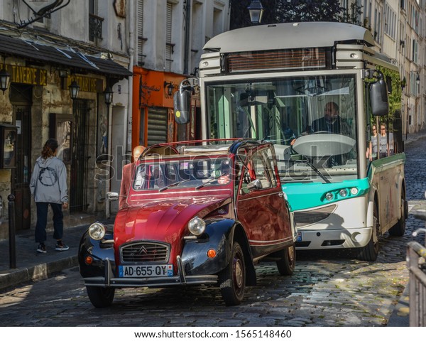 Paris, France - Oct 4, 2018. Vintage car\
on old street in Montmartre district in Paris, France. Montmartre\
is a large hill in Paris 18th\
arrondissement.