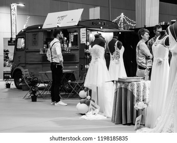 PARIS, FRANCE - OCT 6, 2018: Wedding Exhibition Paris 2018 With People -customers Admiring Dresses Near Food Truck - Black And White